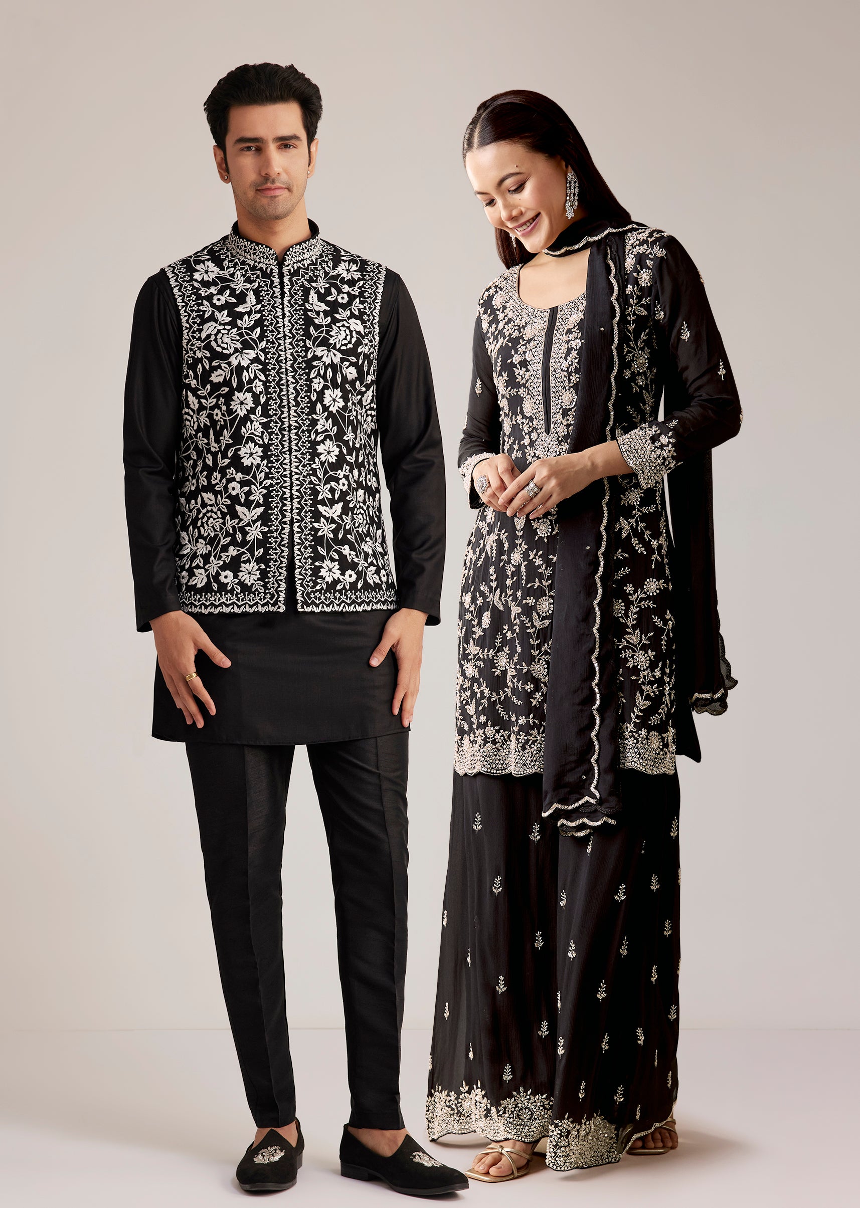 Midnight Black Royal Pair – Pakistani Style Palazzo Suit For Her And Black Silk Kurta With Embroidered Nehru Jacket For Him