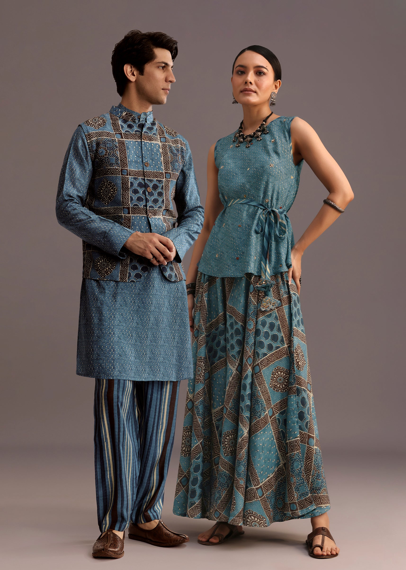 Coordinated Festive Couple Set – Blue Printed Kurti Palazzo Set With Embroidery For Her And Blue Linen Kurta Jacket Set With Ajrakh Print For Him