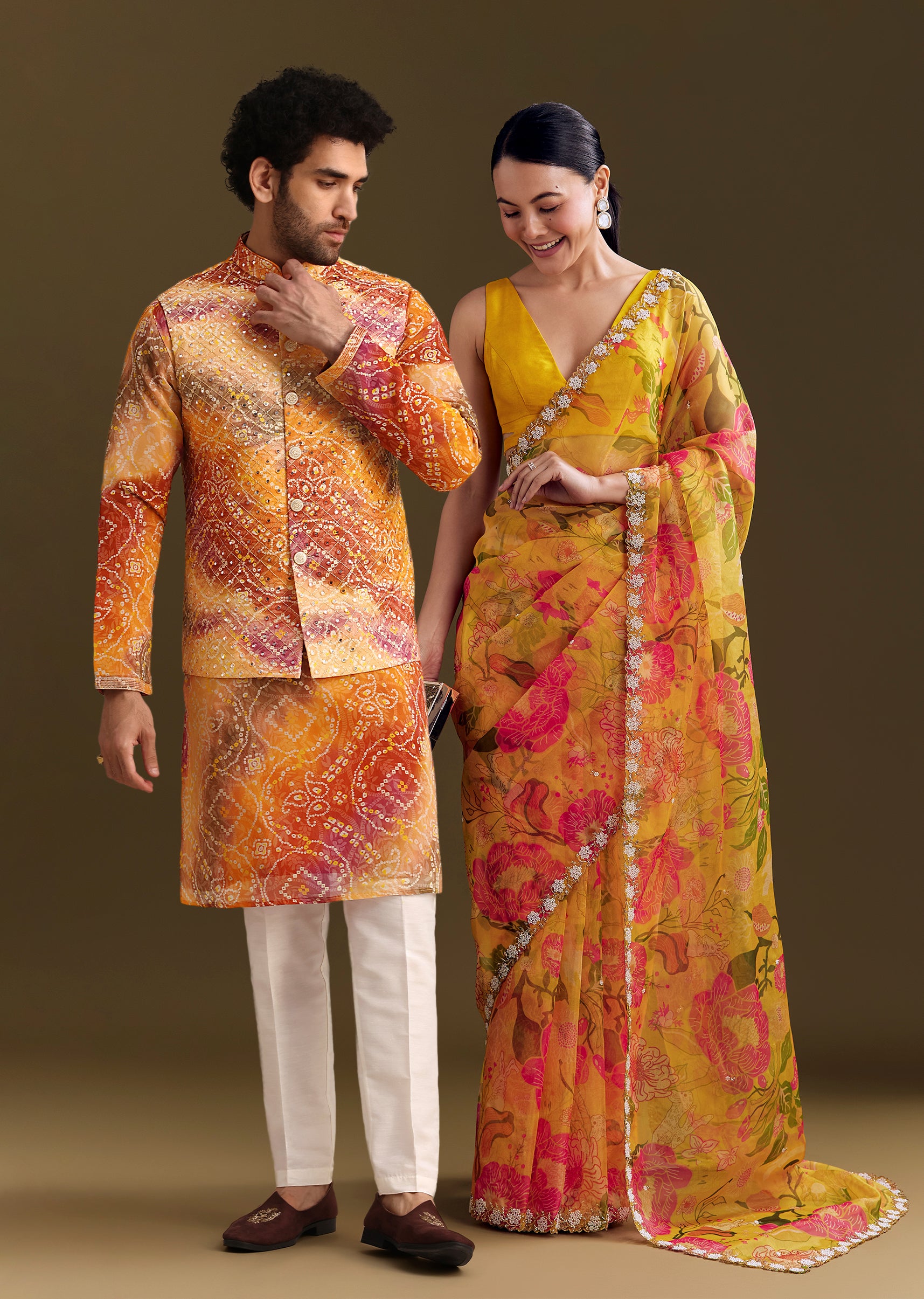 Sunny Festive Couple Set – Yellow Organza Floral Saree With Beaded Border For Her And Orange Tie-Dye Jacket Kurta Set With Mirror Work For Him