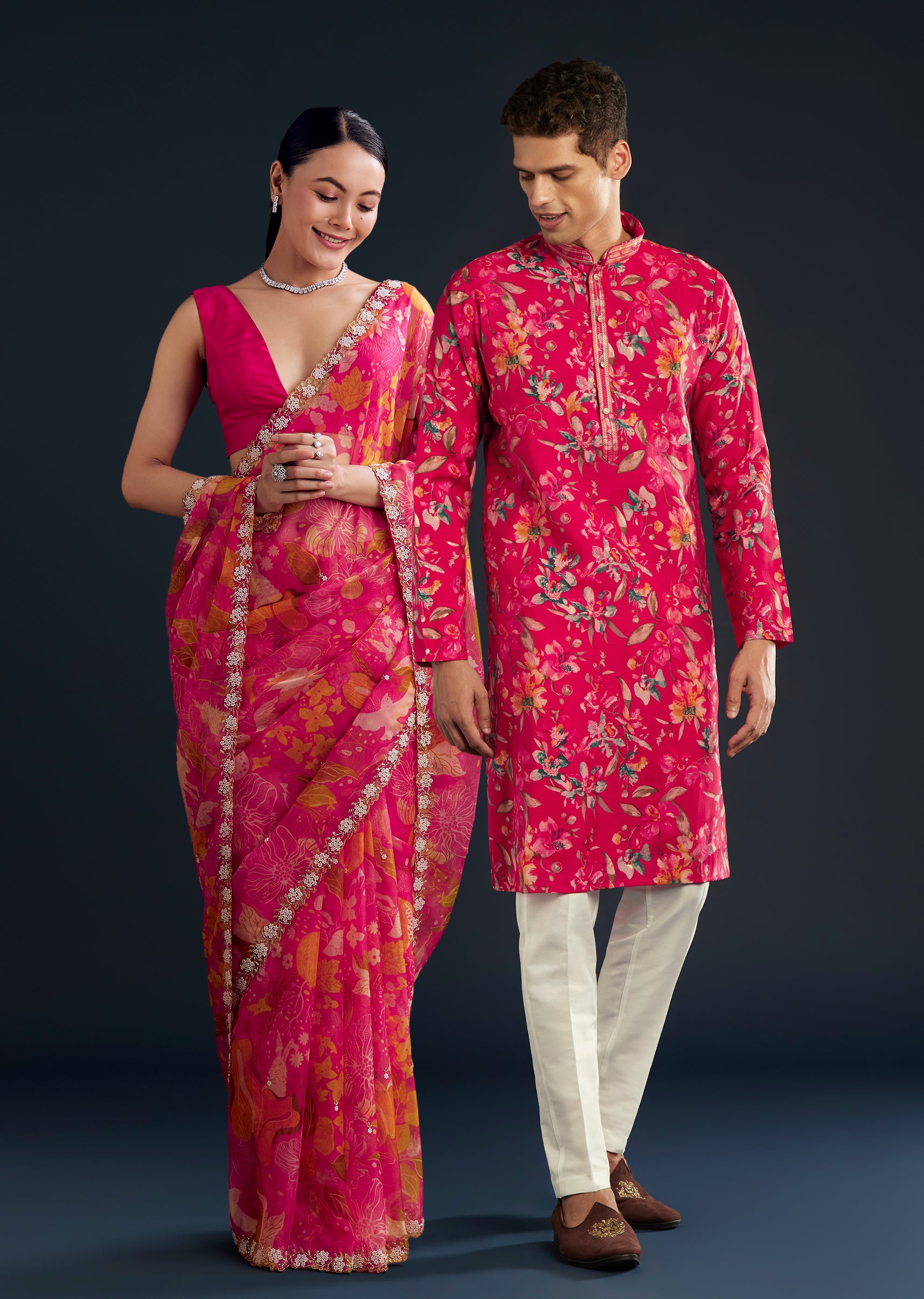 Romantic Festive Couple Set – Pink Organza Floral Saree With Embellished Border For Her And Pink Silk Kurta Set With Floral Motifs For Him