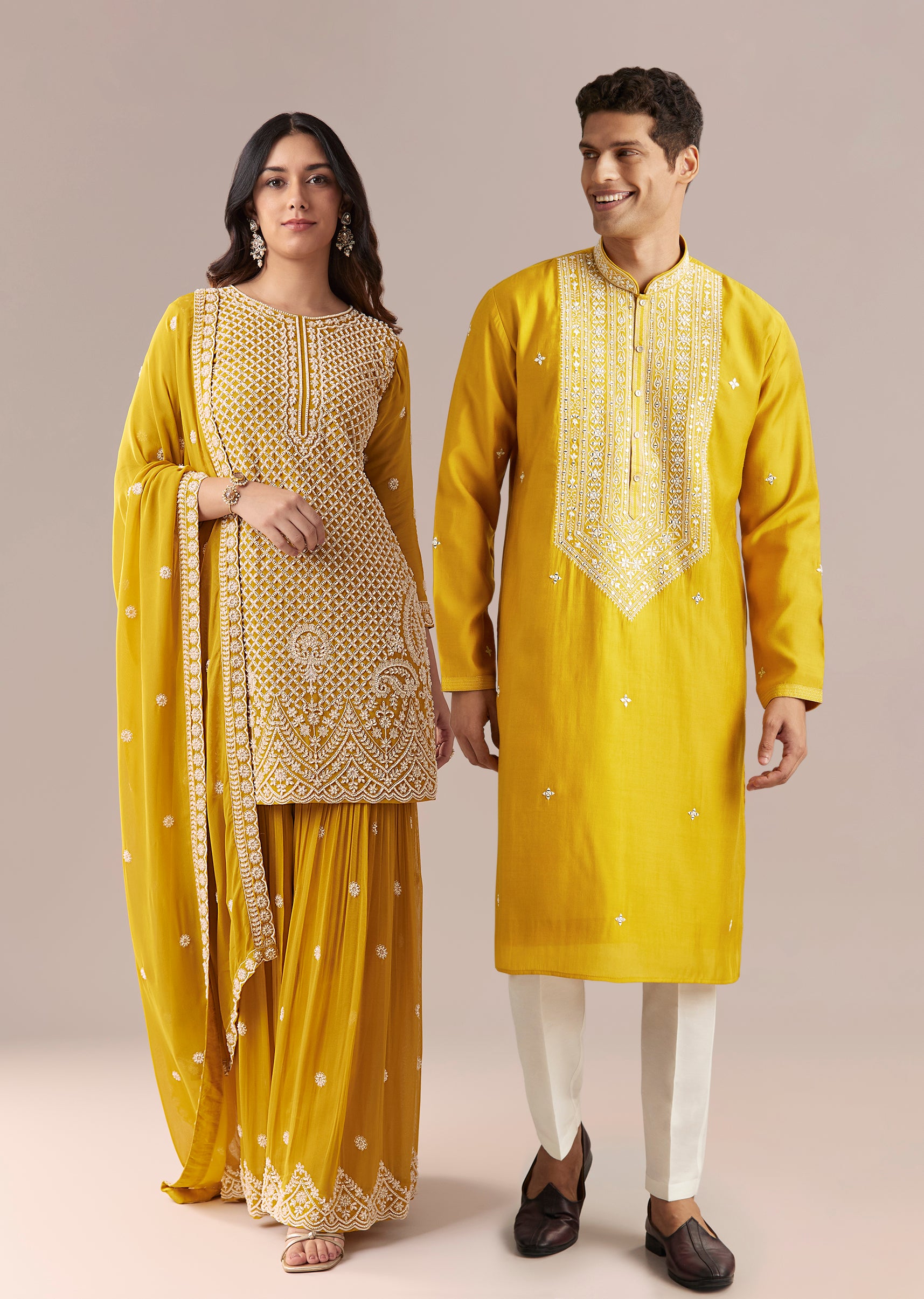 Mustard Yellow Coordinated Attire – Embellished Sharara Suit For Her And Yellow Silk Mirror Work Kurta Set For Him